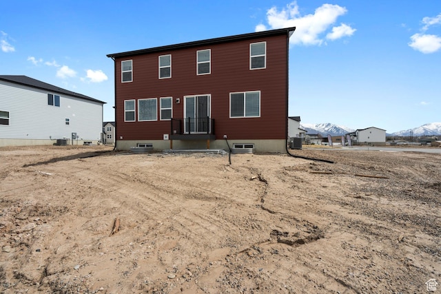 rear view of property featuring a mountain view and central AC