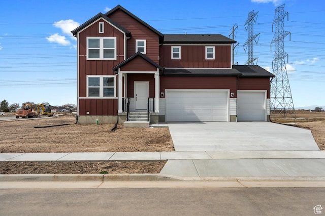 view of front of house with board and batten siding, concrete driveway, and a garage