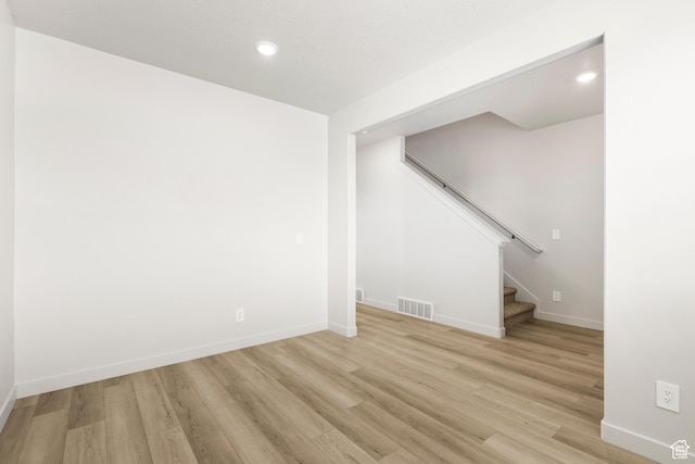 basement with light wood finished floors, stairway, baseboards, and recessed lighting