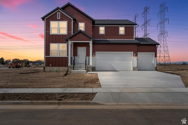 view of front of home with board and batten siding, concrete driveway, and a garage