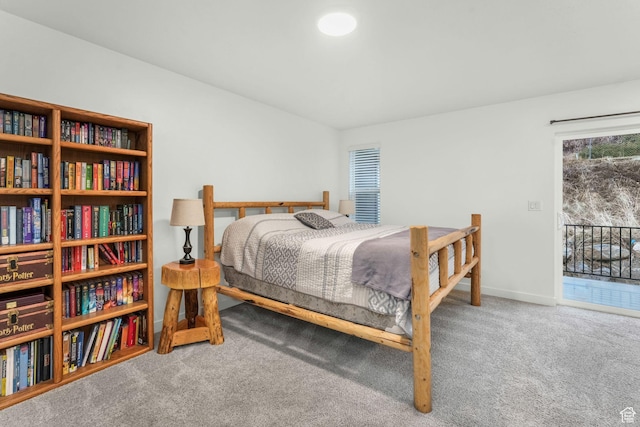 bedroom with carpet flooring and access to outside