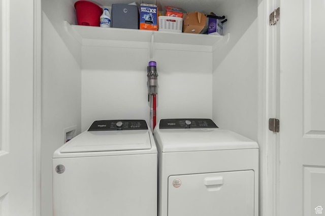 clothes washing area with washer and clothes dryer