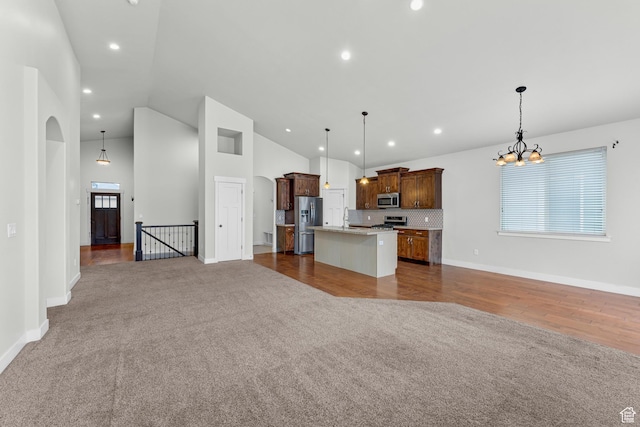 10743 S Autumn Wind Way S, Jordan, UT 84009 - kitchen with stainless steel appliances, a kitchen island, pendant lighting, and dark carpet