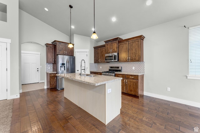 10743 S Autumn Wind Way S, Jordan, UT 84009 - kitchen with sink, stainless steel appliances, light stone counters, an island with sink, and decorative light fixtures