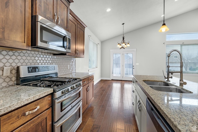 10743 S Autumn Wind Way S, Jordan, UT 84009 - kitchen with pendant lighting, sink, lofted ceiling, appliances with stainless steel finishes, and light stone counters