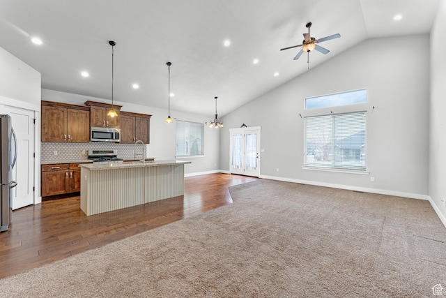10743 S Autumn Wind Way S, Jordan, UT 84009 - kitchen with appliances with stainless steel finishes, a healthy amount of sunlight, a center island with sink, and decorative light fixtures