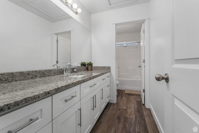 3457 W Hamm Ln, Herriman, UT 84096 - bathroom featuring wood finished floors, toilet, vanity, and tub / shower combination