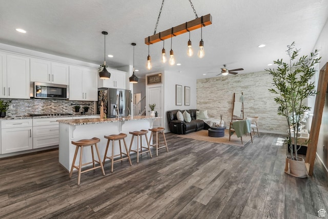 3457 W Hamm Ln, Herriman, UT 84096 - kitchen with appliances with stainless steel finishes, ceiling fan, dark wood-style floors, decorative backsplash, and recessed lighting
