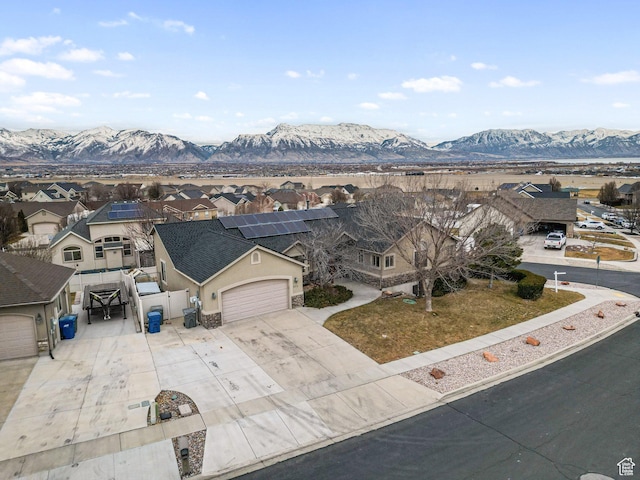 exterior space with a mountain view, a garage, and solar panels