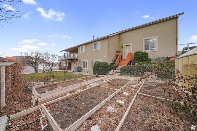 rear view of property featuring a balcony