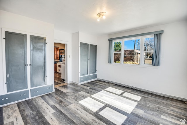 unfurnished bedroom featuring dark wood-type flooring