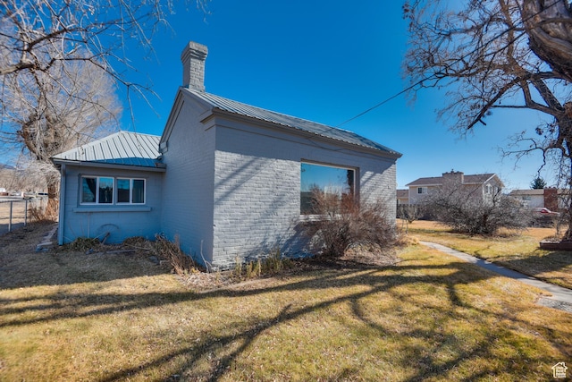 view of side of home featuring a yard
