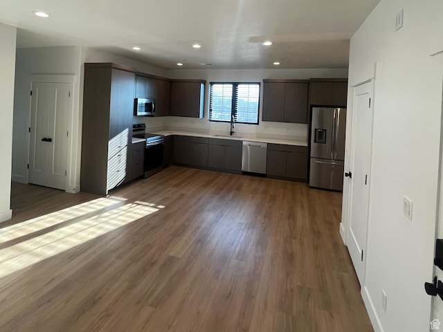 10131 N Redwood, Cedar Hills, UT 84062 - kitchen with dark hardwood / wood-style flooring, sink, dark brown cabinets, and stainless steel appliances