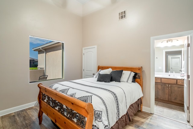3274 W 2530 S, Hurricane, UT 84737 - bedroom featuring connected bathroom, hardwood / wood-style floors, sink, and a high ceiling