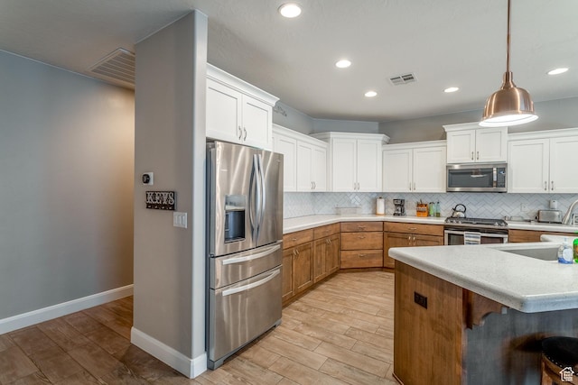 3274 W 2530 S, Hurricane, UT 84737 - kitchen featuring stainless steel appliances, pendant lighting, white cabinets, and backsplash