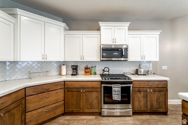 3274 W 2530 S, Hurricane, UT 84737 - kitchen with white cabinetry, backsplash, and stainless steel appliances