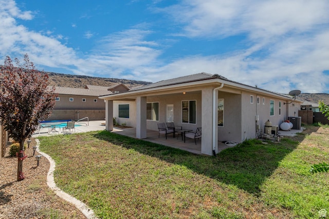 3274 W 2530 S, Hurricane, UT 84737 - rear view of house with central AC, a patio area, and a lawn