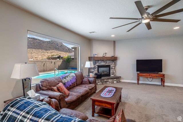 3274 W 2530 S, Hurricane, UT 84737 - living room with a stone fireplace, carpet floors, and ceiling fan
