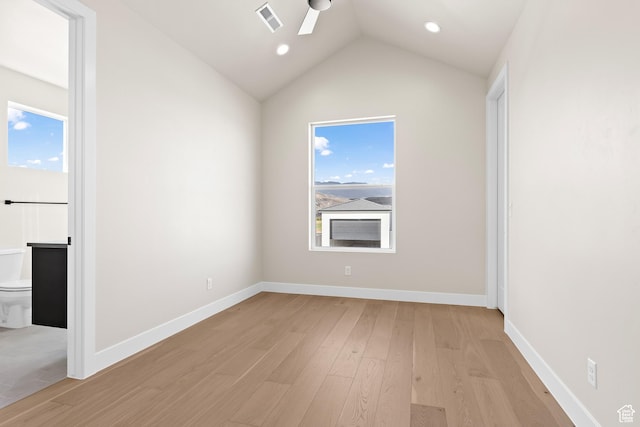 empty room featuring lofted ceiling and light hardwood / wood-style floors