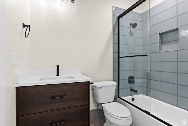 full bathroom with vanity, bath / shower combo with glass door, and toilet