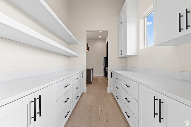 hall with light hardwood / wood-style floors