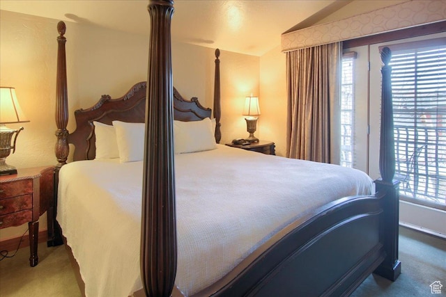 bedroom featuring vaulted ceiling and carpet flooring