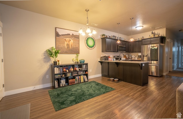 14497 S Ronan Ln E Unit O-002, Herriman, UT 84096 - kitchen featuring pendant lighting, a breakfast bar area, dark brown cabinetry, kitchen peninsula, and stainless steel appliances