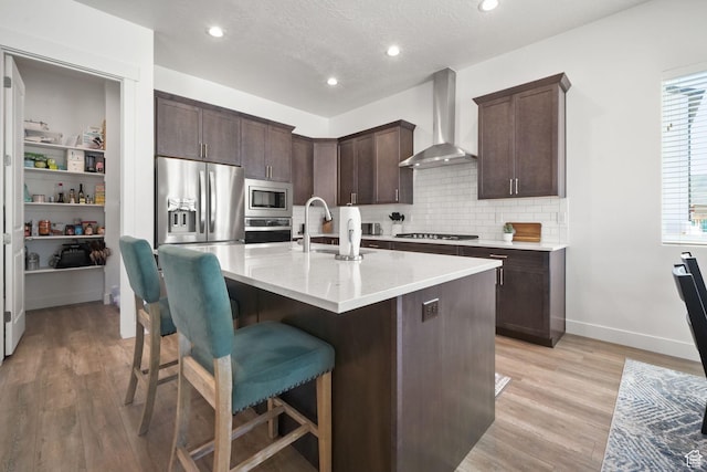 1712 S 1160 E, Heber City, UT 84032 - kitchen with wall chimney exhaust hood, sink, an island with sink, stainless steel appliances, and backsplash