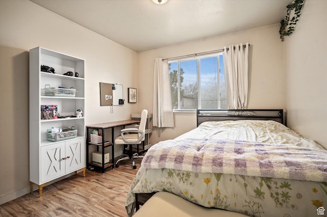 bedroom featuring baseboards and light wood-style floors