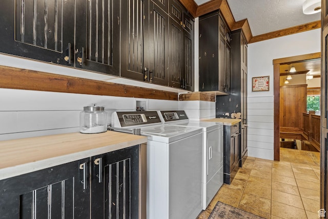 361 N 100 W, Holden, UT 84636 - laundry area with wooden walls, cabinets, ornamental molding, a textured ceiling, and washing machine and clothes dryer