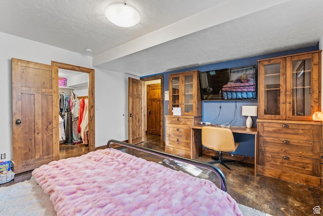 361 N 100 W, Holden, UT 84636 - bedroom with a walk in closet, built in desk, a textured ceiling, and a closet