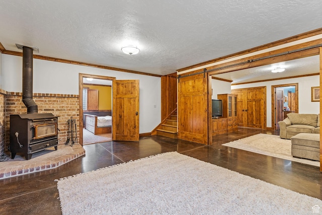 361 N 100 W, Holden, UT 84636 - living room featuring ornamental molding, a barn door, a wood stove, and a textured ceiling