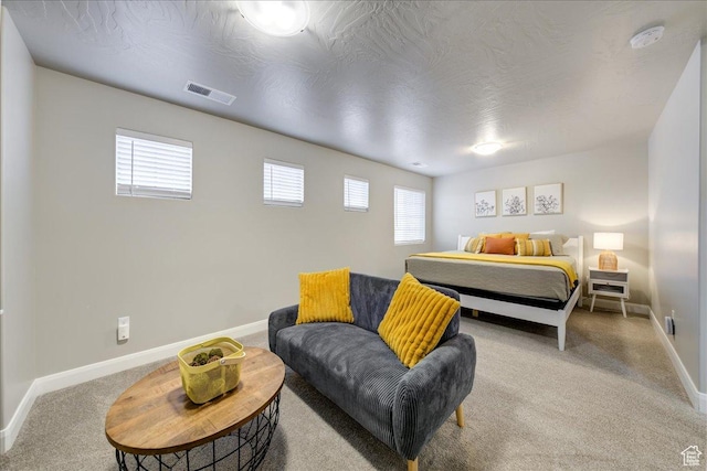 carpeted bedroom featuring a textured ceiling