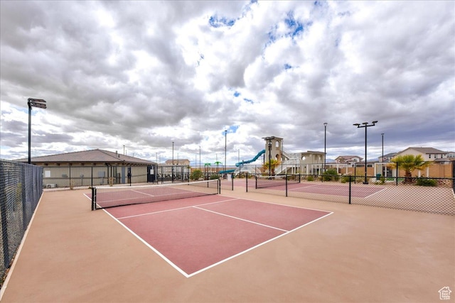 view of sport court with a playground