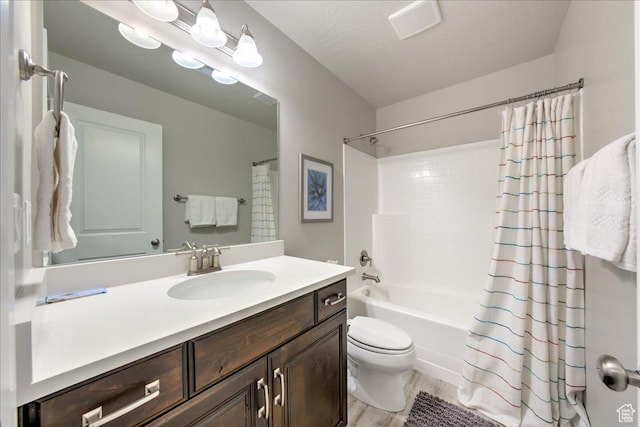 full bathroom with vanity, hardwood / wood-style flooring, toilet, and shower / bath combo
