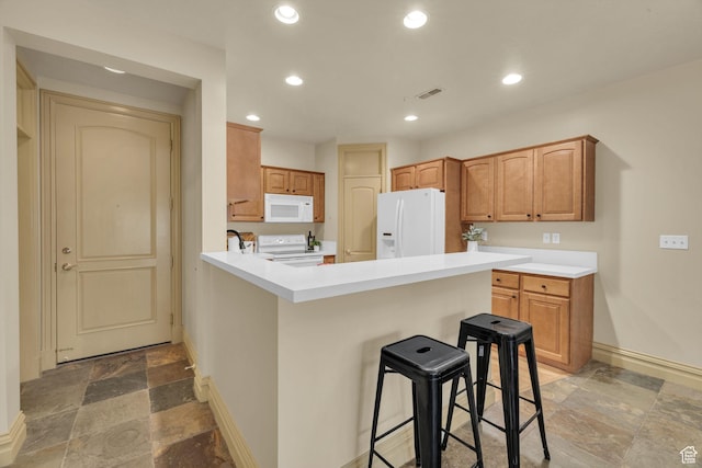 150 S 300 E Unit 202, Salt Lake City, UT 84111 - kitchen with a kitchen breakfast bar, white appliances, and kitchen peninsula