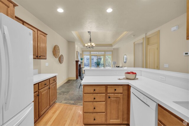 150 S 300 E Unit 202, Salt Lake City, UT 84111 - kitchen featuring pendant lighting, white appliances, a notable chandelier, a tray ceiling, and light hardwood / wood-style floors