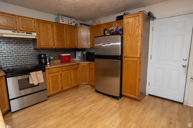 1904 N Rocky Ford Rd, Sigurd, UT 84657 - kitchen featuring stainless steel appliances, backsplash, a textured ceiling, and light hardwood / wood-style flooring