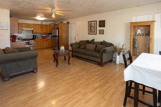 1904 N Rocky Ford Rd, Sigurd, UT 84657 - living room featuring ceiling fan, light hardwood / wood-style floors, and a textured ceiling