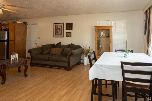 1904 N Rocky Ford Rd, Sigurd, UT 84657 - dining space with ceiling fan, light hardwood / wood-style floors, and a textured ceiling