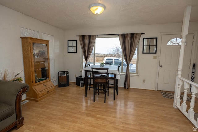 1904 N Rocky Ford Rd, Sigurd, UT 84657 - dining room with heating unit, light hardwood / wood-style flooring, and a textured ceiling