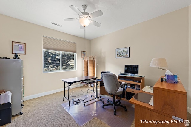 carpeted office space with ceiling fan