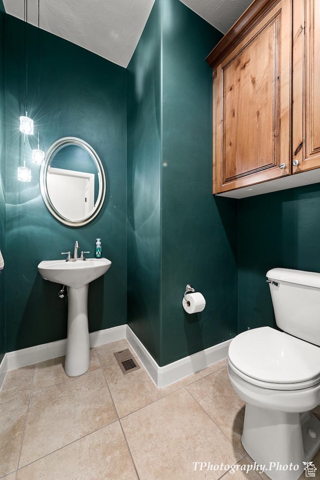 bathroom with tile patterned flooring and toilet