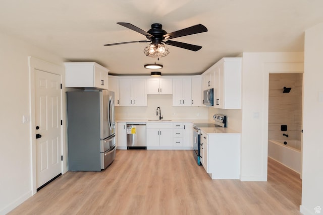 1898 N Rocky Ford Dr, Sigurd, UT 84657 - kitchen with stainless steel appliances, a sink, ceiling fan, and light wood-style flooring