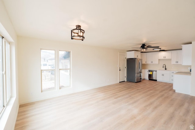 1898 N Rocky Ford Dr, Sigurd, UT 84657 - kitchen featuring appliances with stainless steel finishes, light wood finished floors, light countertops, a ceiling fan, and a sink