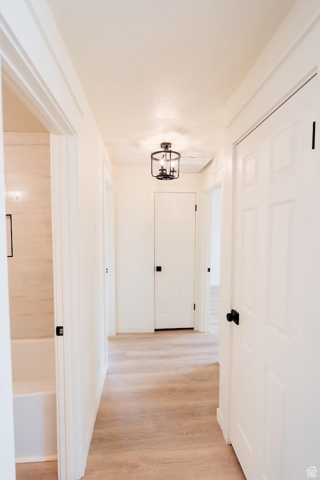 1898 N Rocky Ford Dr, Sigurd, UT 84657 - hall featuring a chandelier, light wood finished floors, and baseboards