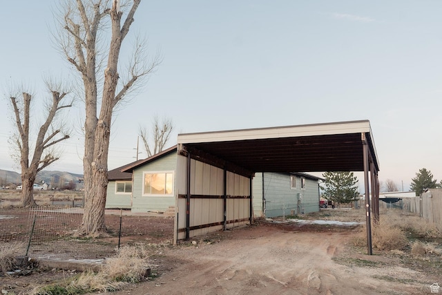 1898 N Rocky Ford Dr, Sigurd, UT 84657 - view of vehicle parking featuring a carport, fence, and dirt driveway