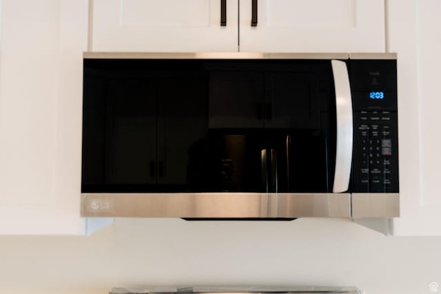 1898 N Rocky Ford Dr, Sigurd, UT 84657 - kitchen view of dark cabinetry, stainless steel microwave, and light countertops