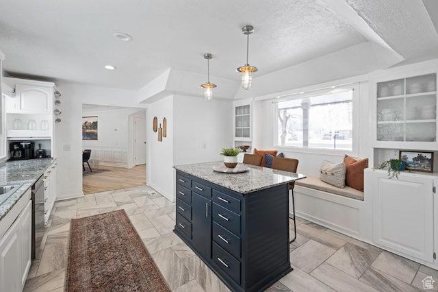 575 N 300 E, Tremonton, UT 84337 - kitchen featuring dark cabinets, decorative light fixtures, dishwasher, a kitchen bar, and a center island