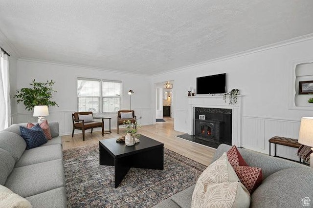 575 N 300 E, Tremonton, UT 84337 - living area with crown molding, a textured ceiling, wainscoting, and wood finished floors